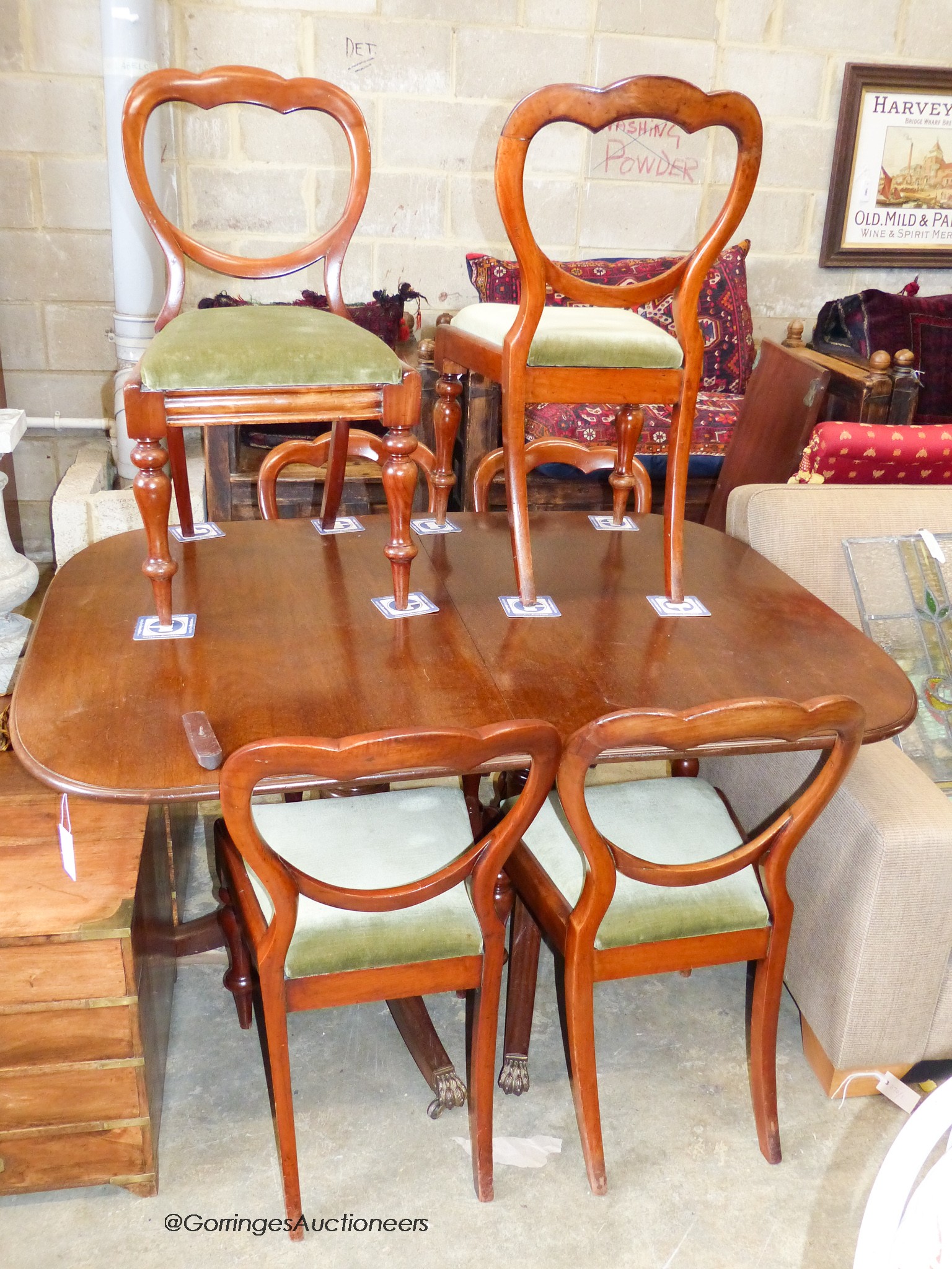 A George III style mahogany twin pillar extending dining table and six Victorian balloon back chairs, table 182 cm extended, one spare leaf, W-110, H-72cm.